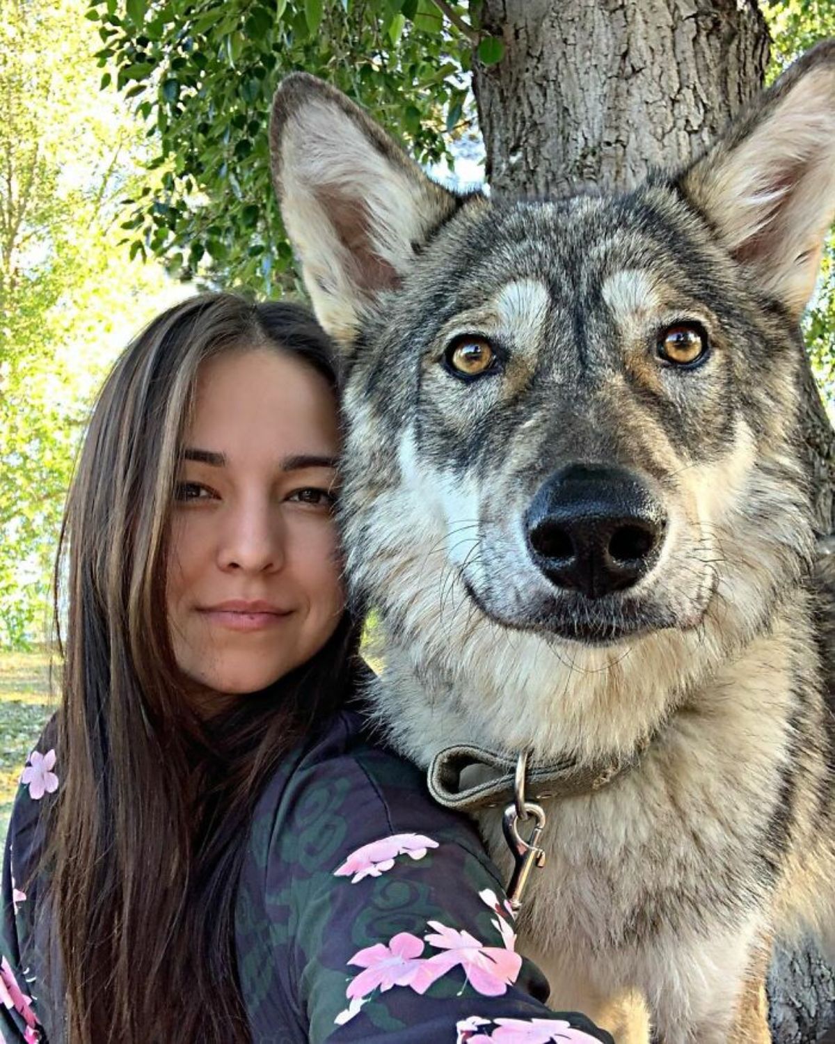 wolf standing next to woman in black
