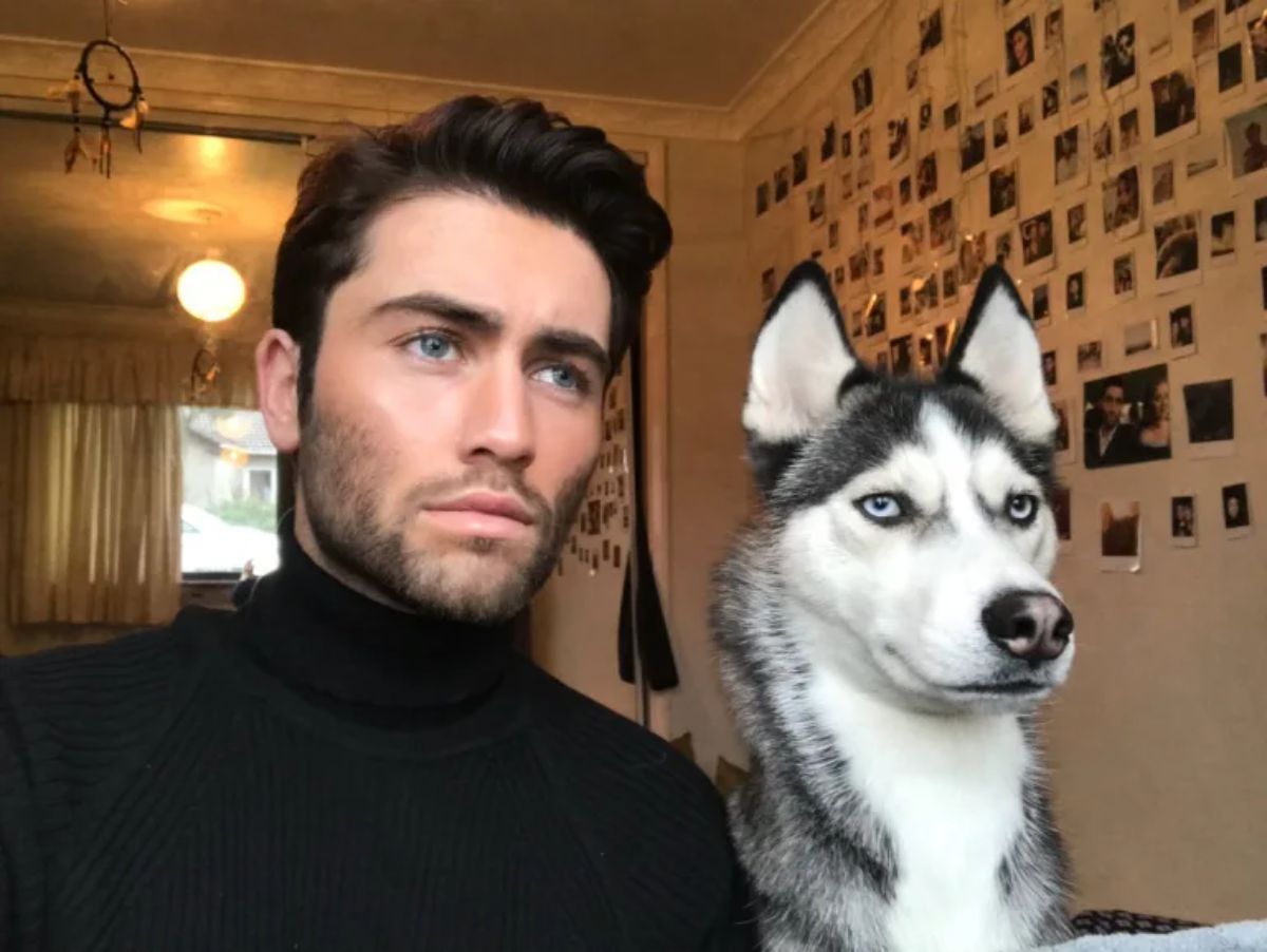 black and white husky with a man with both of them looking serious