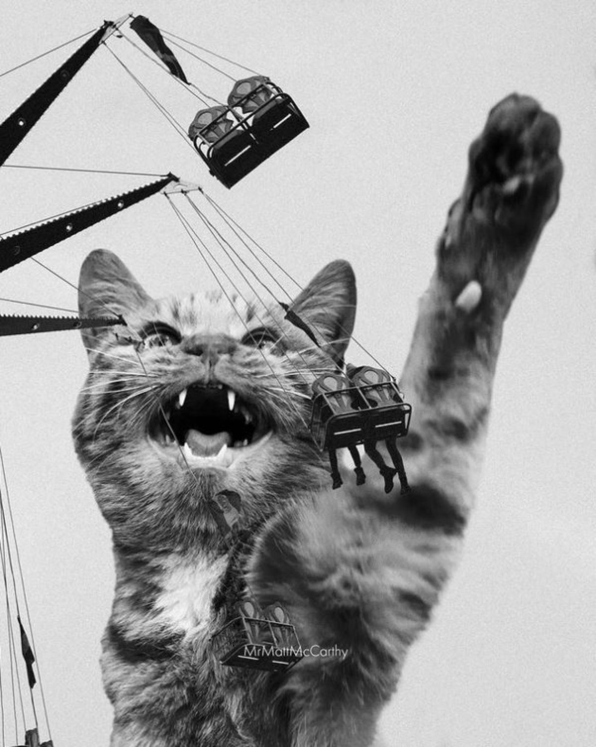 black and white image of large photoshopped cat trying to hit at the people on the ferris wheel